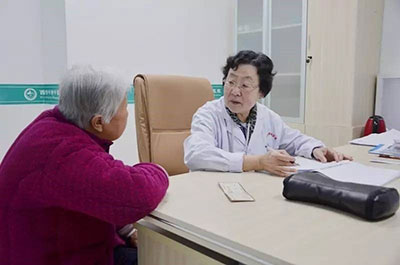内科医生王德玲在亲切询问患者病情病史